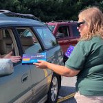 Kathy McFadden (right), a staffer at Sussex County (Del.) Libraries, hands out rapid, at-home COVID-19 testing kits during a drive-through distribution event at Seaford (Del.) District Library in August 2021. Photo: Delaware Division of Libraries