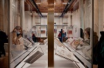 A photo of glass cases showcasing the 'Treasurse" exhibit at New York Public Library