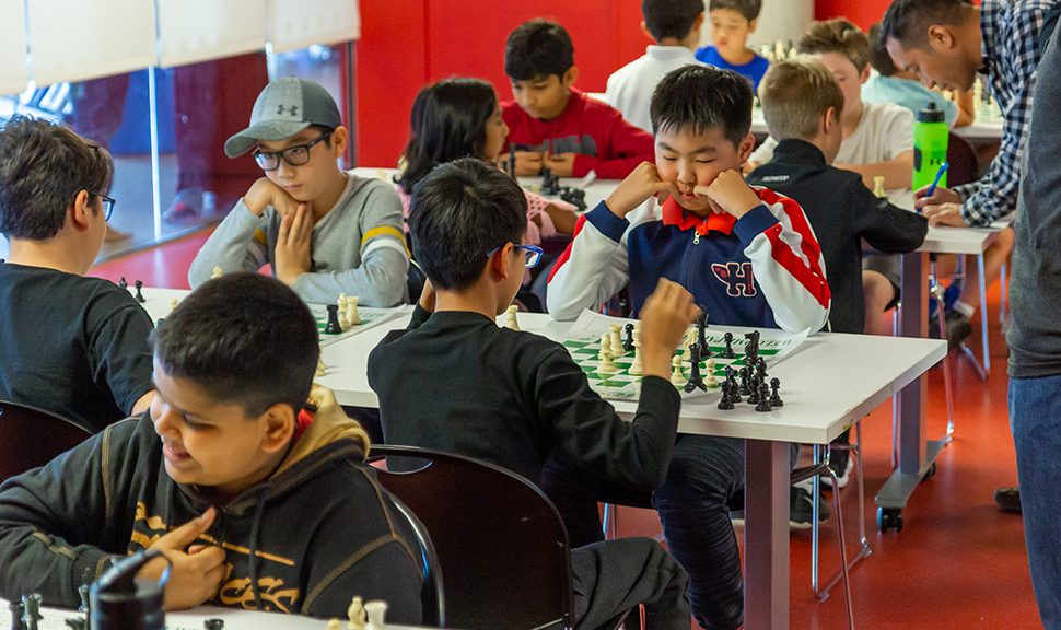 Photo of young people playing chess