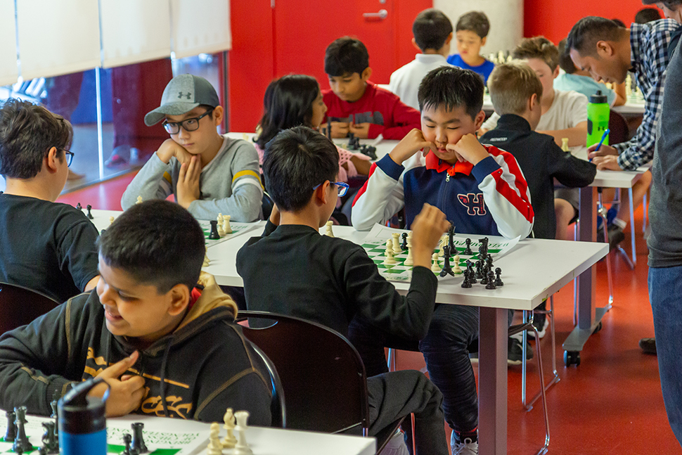 Photo of young people playing chess