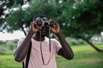 Man in park looking through binoculars