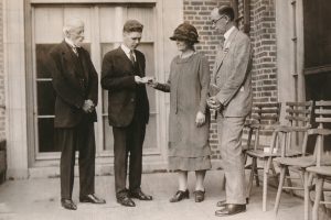 Fenton T. Newbery (located at left), a direct descendent of John Newbery, watches author Arthur Bowie Chrisman receive the 1926 Newbery Medal for Shen of the Sea from Nina C. Brotherton, chair of ALA’s Children’s Librarians Section. Frederic G. Melcher (located at right), who instituted the Newbery Medal, looks on. Photo from the ALA Archives.
