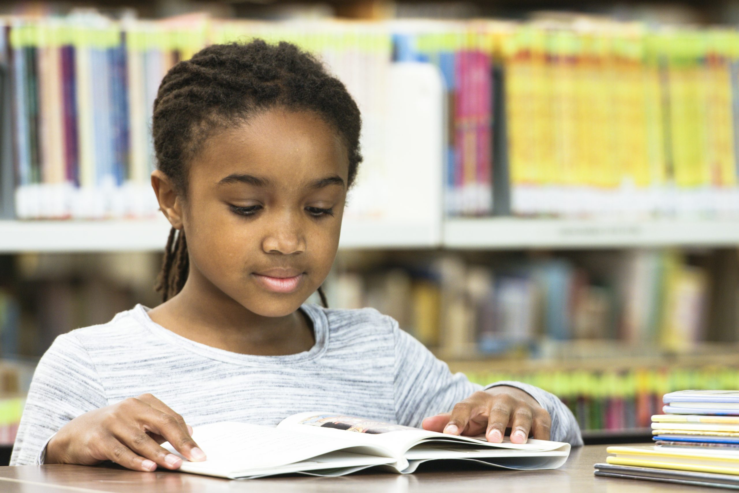 A student reads a book in the library