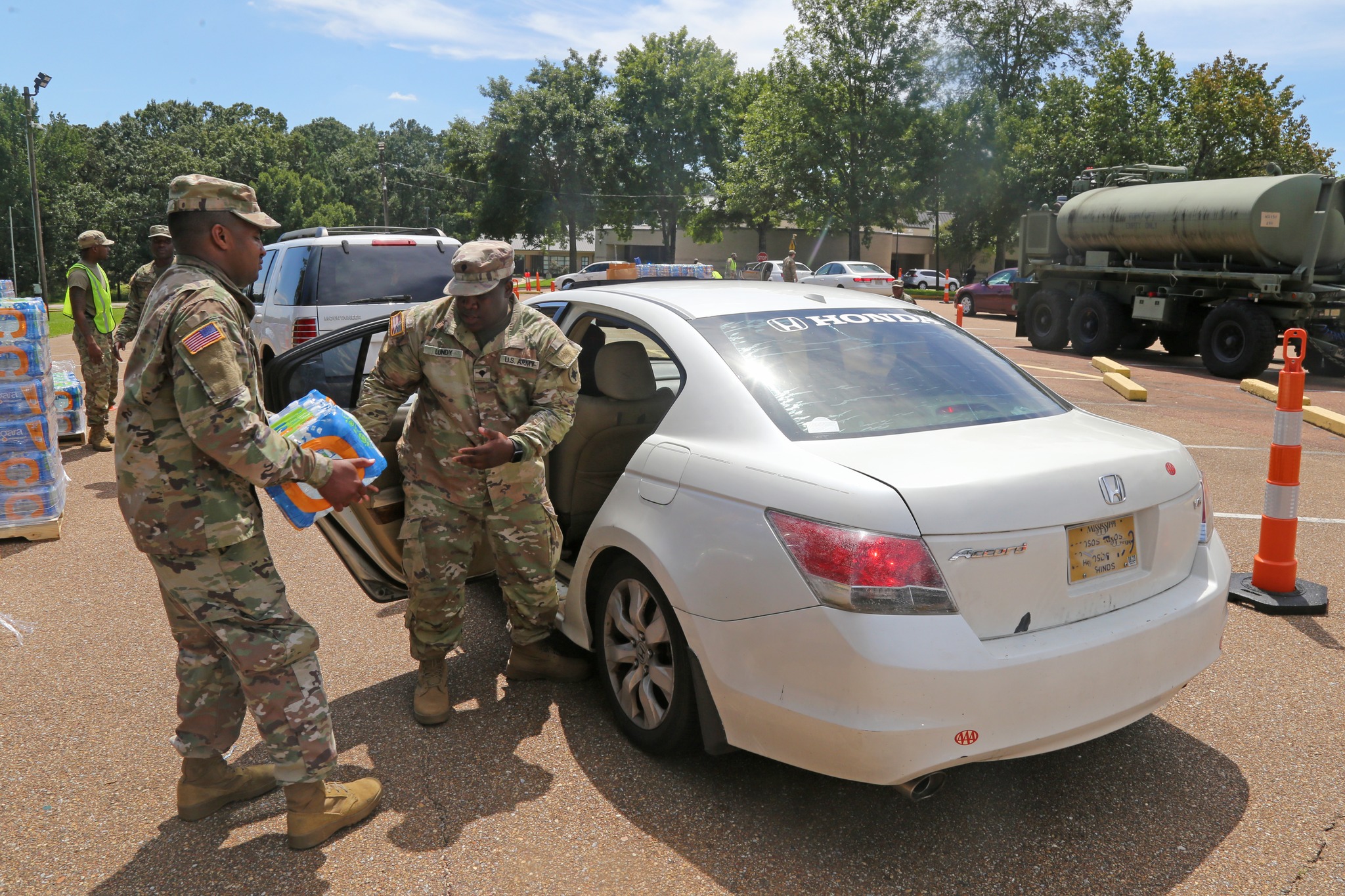 The Army National Guard distribute water at the Hinds Community College's Academic Technical campus during Jackson, Mississippi's ongoing water crisis.