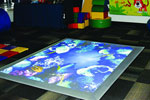 Experia USA’s interactive game floor projects images that react to movement and play.