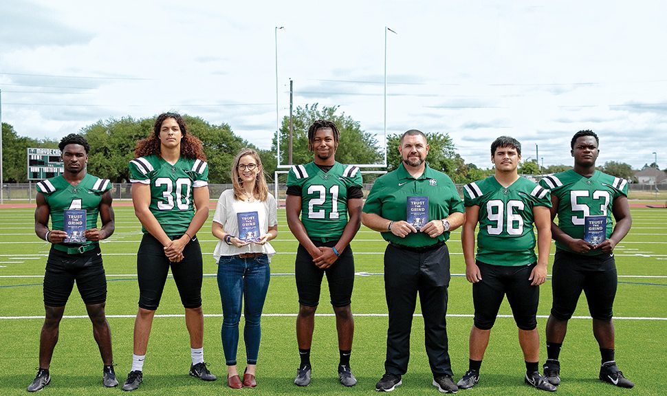 Jessica Fitzpatrick (third from left) with Coach J. Jensen (third from right) and members of the Mayde Creek High School football team