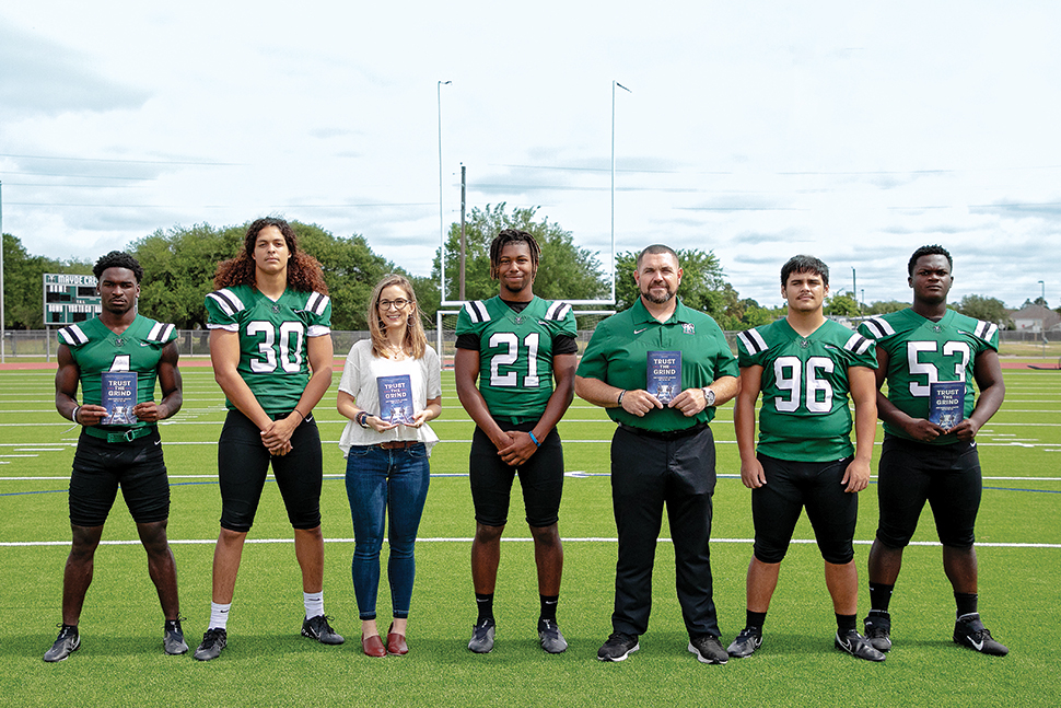 Jessica Fitzpatrick (third from left) with Coach J. Jensen (third from right) and members of the Mayde Creek High School football team