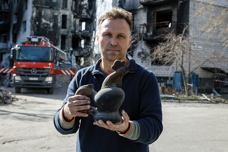 Ihor Poshyvailo, founder of Maidan Museum in Kyiv, holds the ceramic cockerel that has become a symbol of Ukrainian resistance.