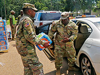 National Guard loading bottled water into a car