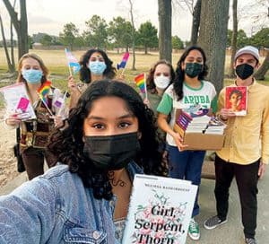 Photo of Cameron Samuels, along with a group of students from Katy (Tex.) Independent School District, preparing to distribute books with LGBTQ+ themes to their classmates in afterschool clubs.