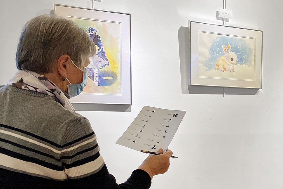 A student from the English for Older Beginners class at Jones Library in Amherst, Massachusetts works on a scavenger hunt during one of the class's field trips.