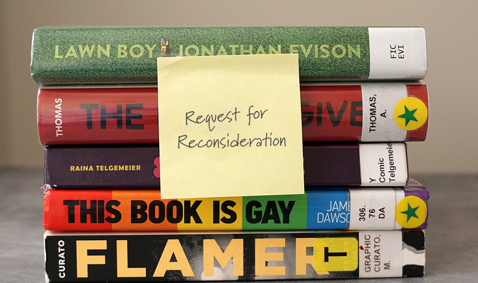 Stack of five library books with a post-it note that reads "Request for Reconsideration"