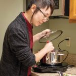 Aydin Kwan, adult services librarian at Sunnyvale Public Library uses an induction cooktop available for loan.