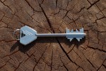 Old fashioned skeleton key with slots cut to resemble an 8-bit computer character