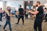 Photo of two people demonstrating sword fighting