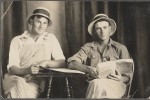 Early 20th century postcard showing two men holding books