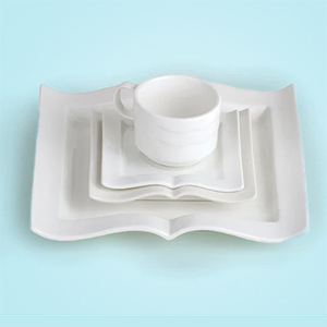 set of book-shaped white plates and a white cup