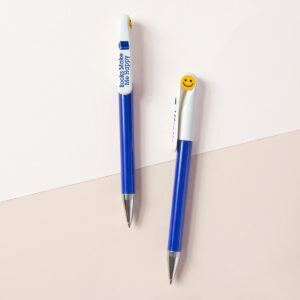 two blue and white pens with yellow smiley-faces