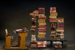 Desk surrounded by stacks of books