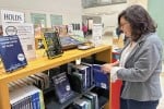 Doreen Horstin, manager of San Fran­cisco Public Library’s Park branch, adds a book to the Read to Recovery shelves, which provide free addiction recovery materials to patrons.