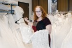Adele Puccio stands with one of the dresses she loans out