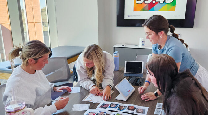 Four students work through an activity with a digital countdown clock in the background.