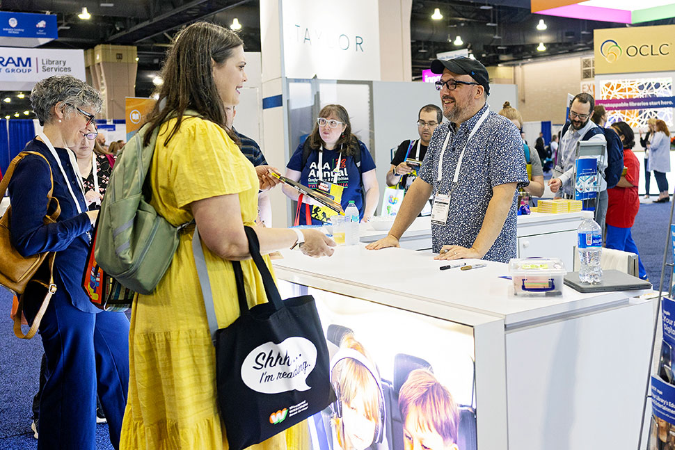 Author Alex Segura signs copies of Dick Tracy at the Hoopla booth. Rebecca Lomax/American Libraries