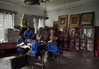 Group of students in an archive in a screencap from How to Build a Library