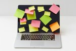 Laptop with sticky notes on its screen