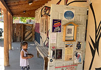 Girl entering a rural library in a screencap from Library Stories: Books on the Backroads