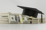 Graduation cap on a pile of moneyac