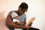 Father reading to his baby