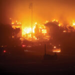 Wildfire with buildings and trees on fire