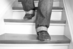Close-up of feet stepping down a stairs