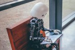 Robot on a bench reading