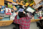 Librarian with his head on desk after cataloging graphic novels