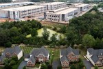 Muddy pond between homes and an Amazon data center