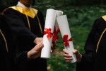 Graduates holding diplomas