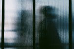 Silhouette of a person through a window