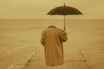 Invisible person in a trenchcoat carrying an umbrella