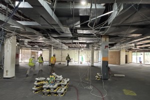 Workers walk through the interior of a library in the middle of its renovation.