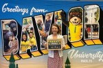 The author in front of a large tourism-style "Greetings from Baylor" sign